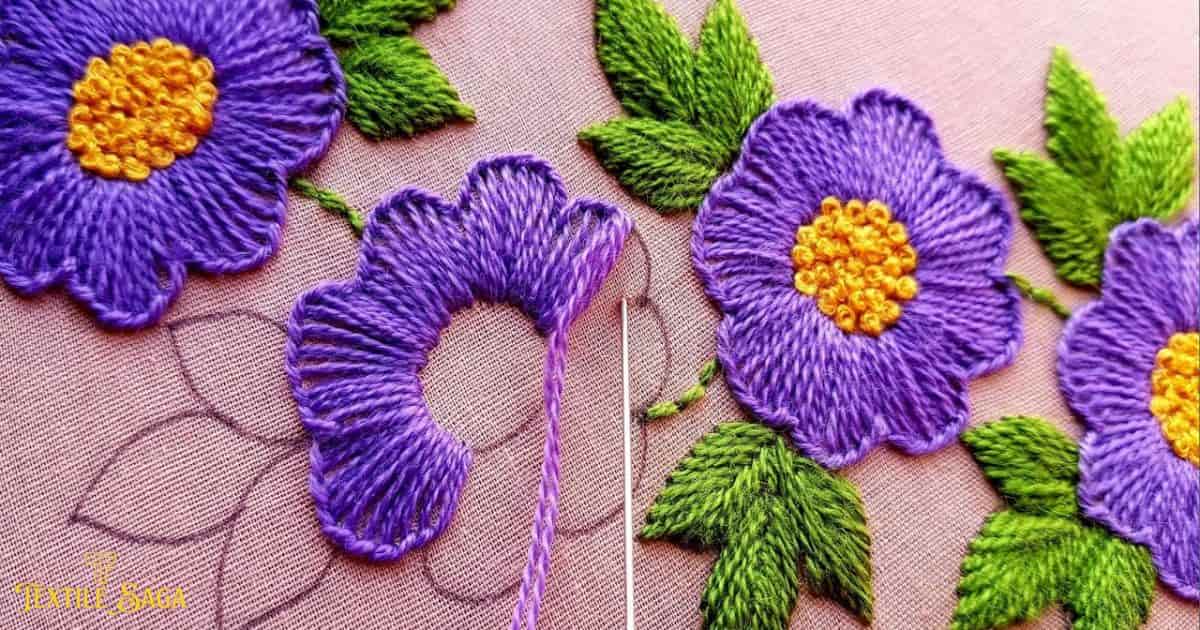 beautiful purple color flowers are embroidered on a cloth with needle.